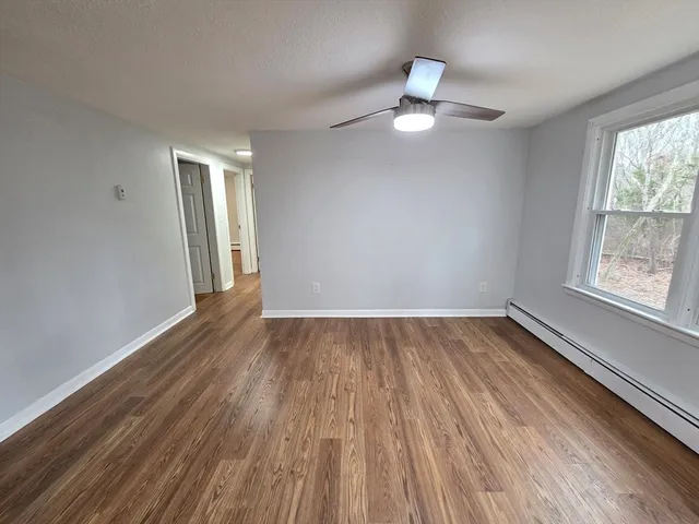 wooden floor in an empty room with a window