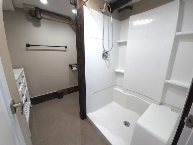 a bathroom with a tub and a shower