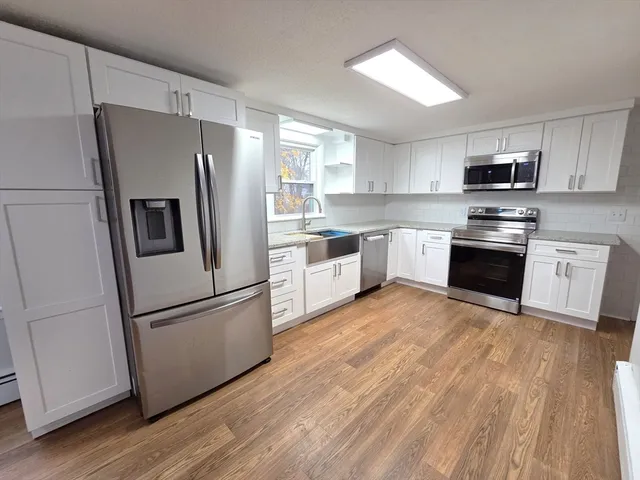 a kitchen with stainless steel appliances a refrigerator sink and microwave