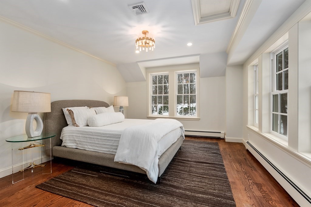 30 Hillcrest Road Weston, MA 02493 - Photo 23 of 29 a bedroom with a large bed chandelier and a window