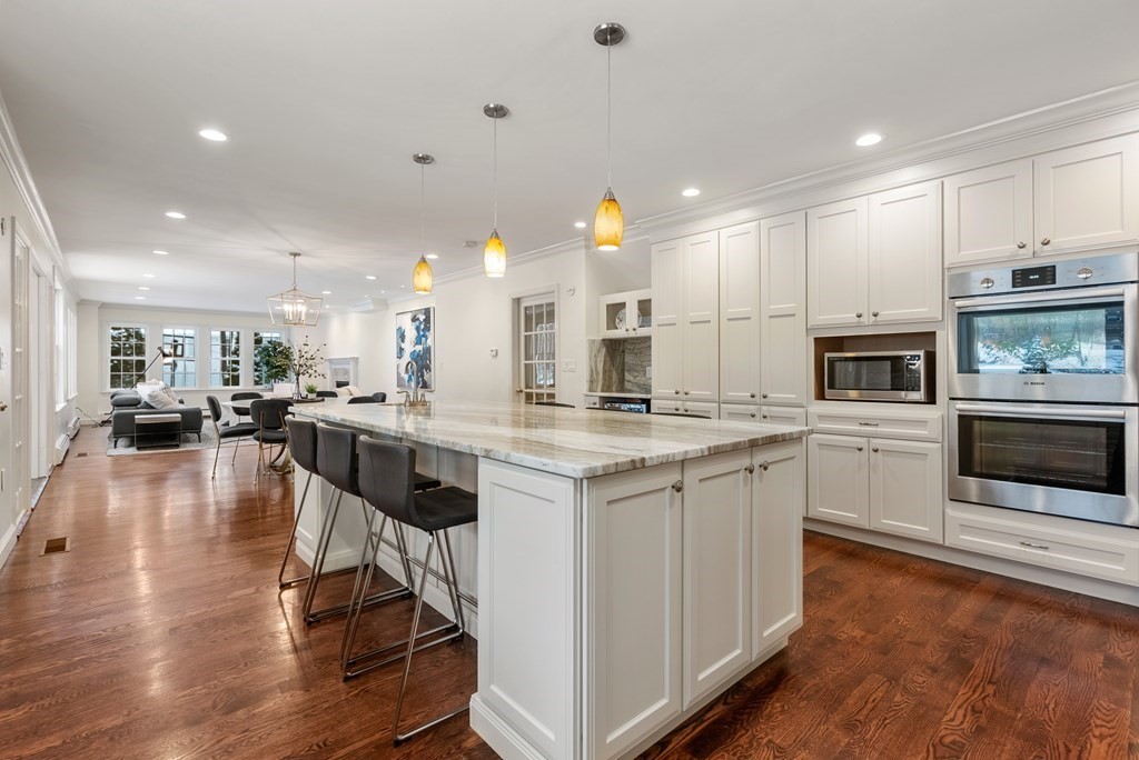 30 Hillcrest Road Weston, MA 02493 - Photo 7 of 29 a kitchen with stainless steel appliances granite countertop a stove top oven a sink dishwasher a refrigerator and white cabinets with wooden floor