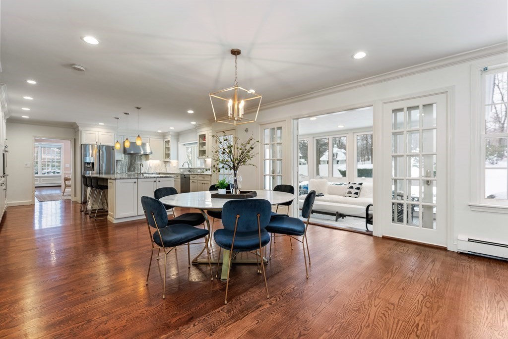 30 Hillcrest Road Weston, MA 02493 - Photo 8 of 29 a view of a dining room and livingroom with furniture wooden floor a rug and a chandelier