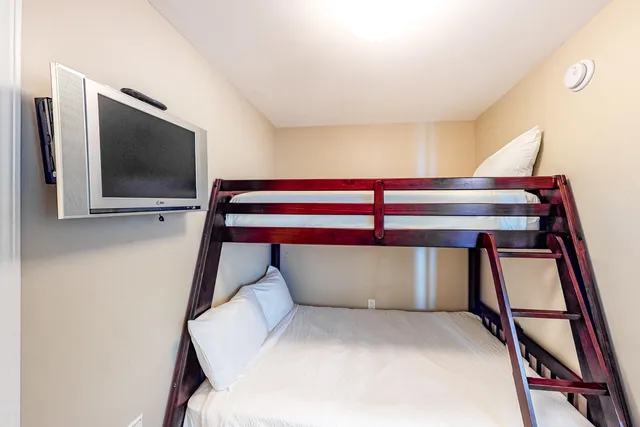 a bedroom with a bed and a flat screen tv