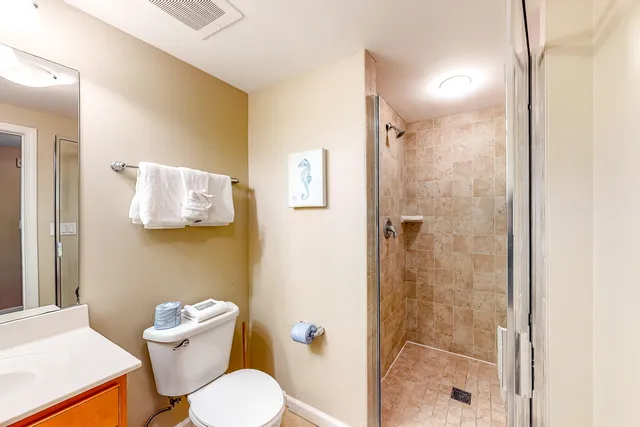 a white toilet sitting next to a bathroom sink