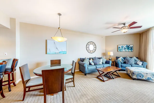 a living room with furniture a rug and a window