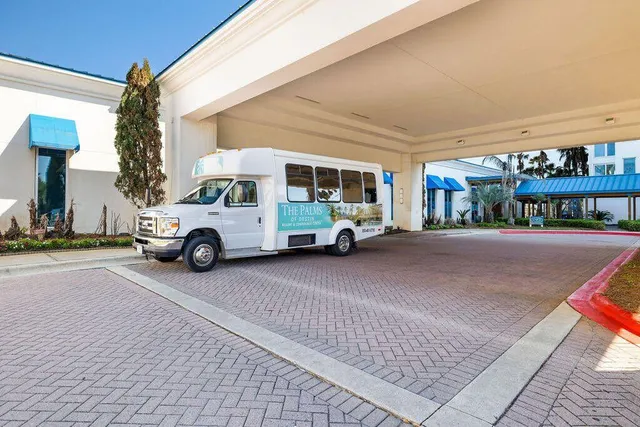 a dining room with stainless steel appliances kitchen island granite countertop a table chairs and a view of living room