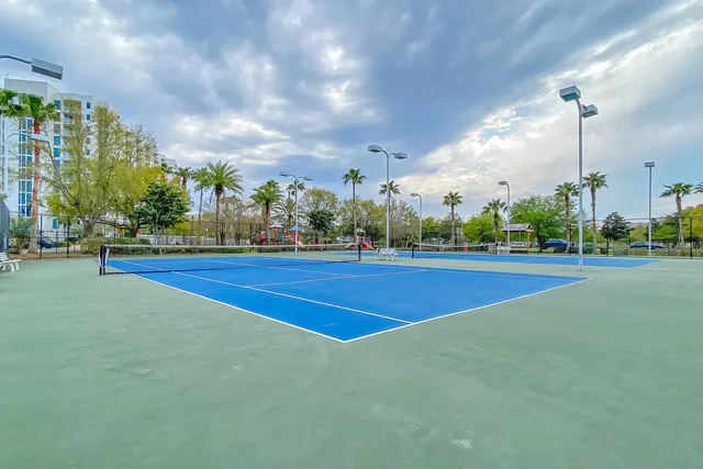 a row of palm trees in front of buildings