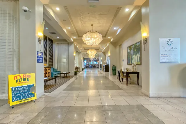 a view of a lobby with dining table and chairs