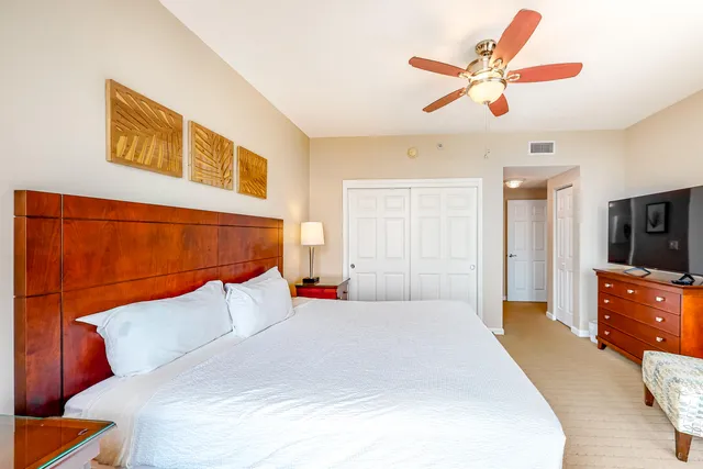 a bedroom with a large bed and a chandelier