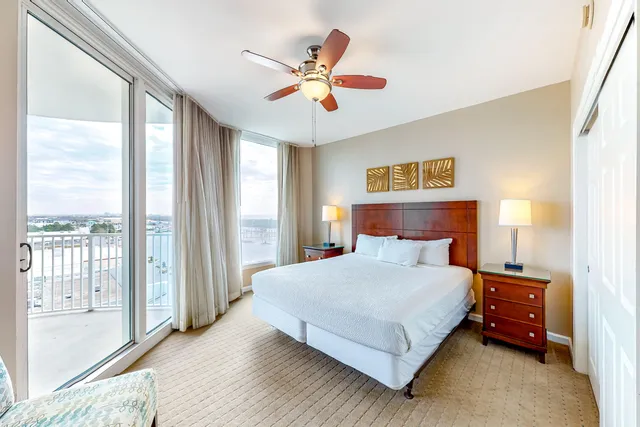 a bedroom with a large bed and a large window