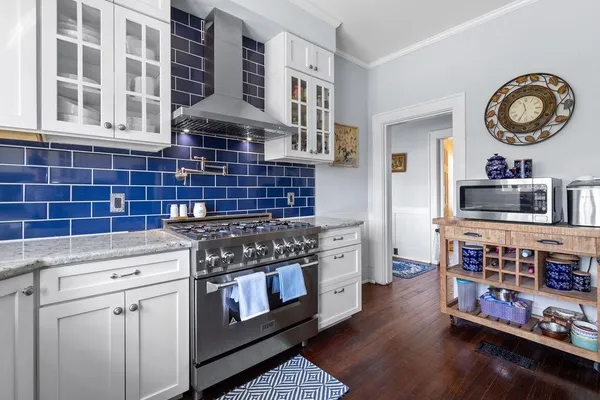 a kitchen with stainless steel appliances granite countertop a stove and a cabinets