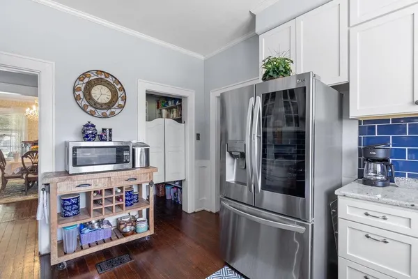 a kitchen with stainless steel appliances a refrigerator and a stove top oven