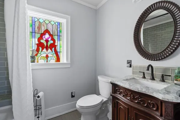 a bathroom with a toilet a sink and a mirror