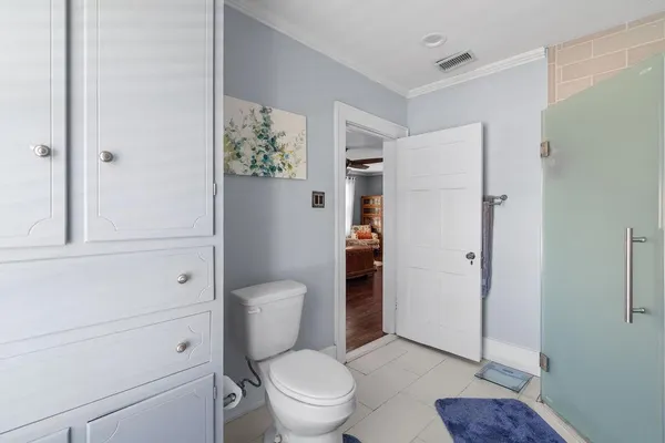 a white toilet sitting next to a bathroom sink