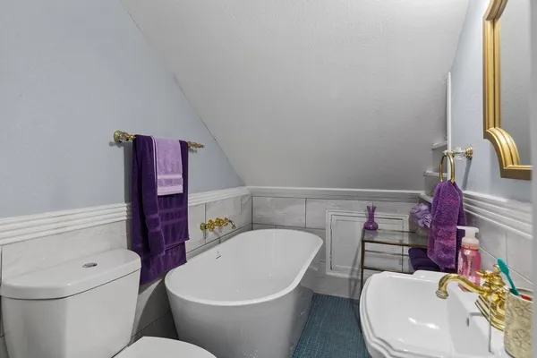 a white toilet sitting next to a bathroom sink