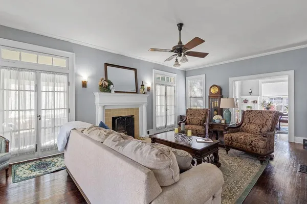 a living room with furniture a fireplace and a large window