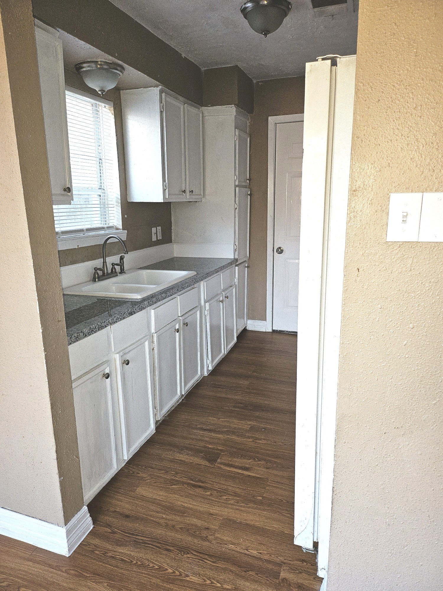 15829 Ridgeroe Lane Houston, TX 77053 - Photo 7 of 15 a kitchen with a sink cabinets appliances and a window