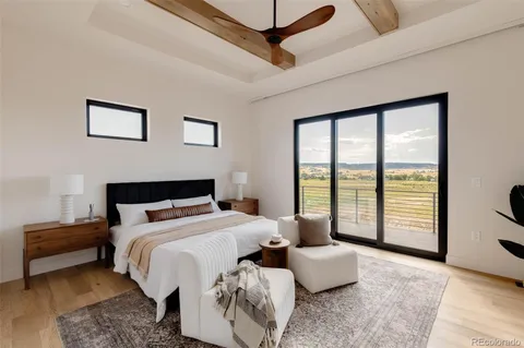 a bedroom with furniture and large windows