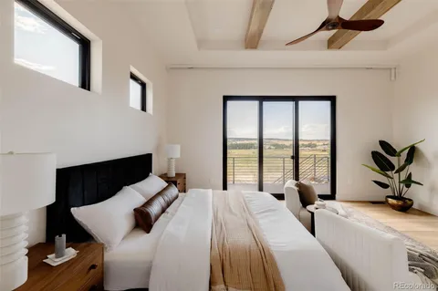 a bedroom with a bed and a large window