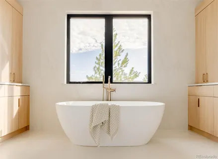 a white tub sitting next to a window