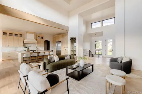 a living room with furniture kitchen view and a window