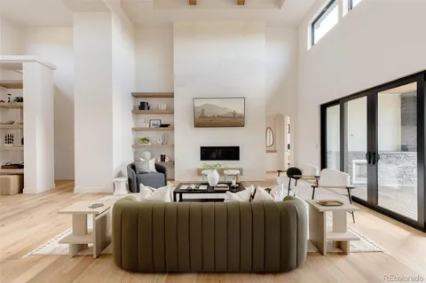 a living room with furniture a large window and a flat screen tv