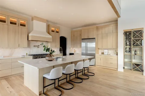 a large kitchen with a table and chairs in it