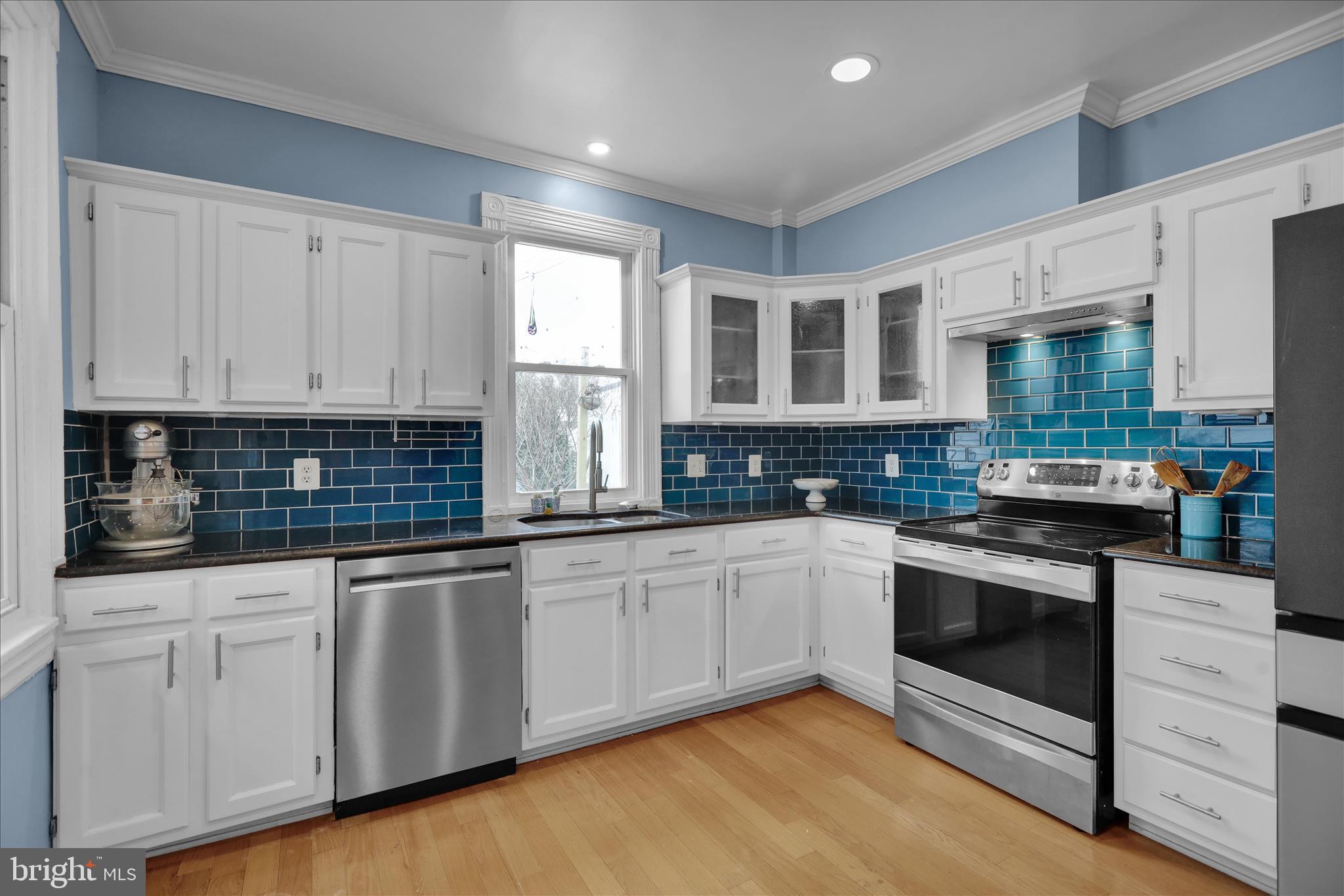 431 East Orange Street Lancaster, PA 17602 - Photo 15 of 46 a kitchen with granite countertop white cabinets stainless steel appliances and a sink