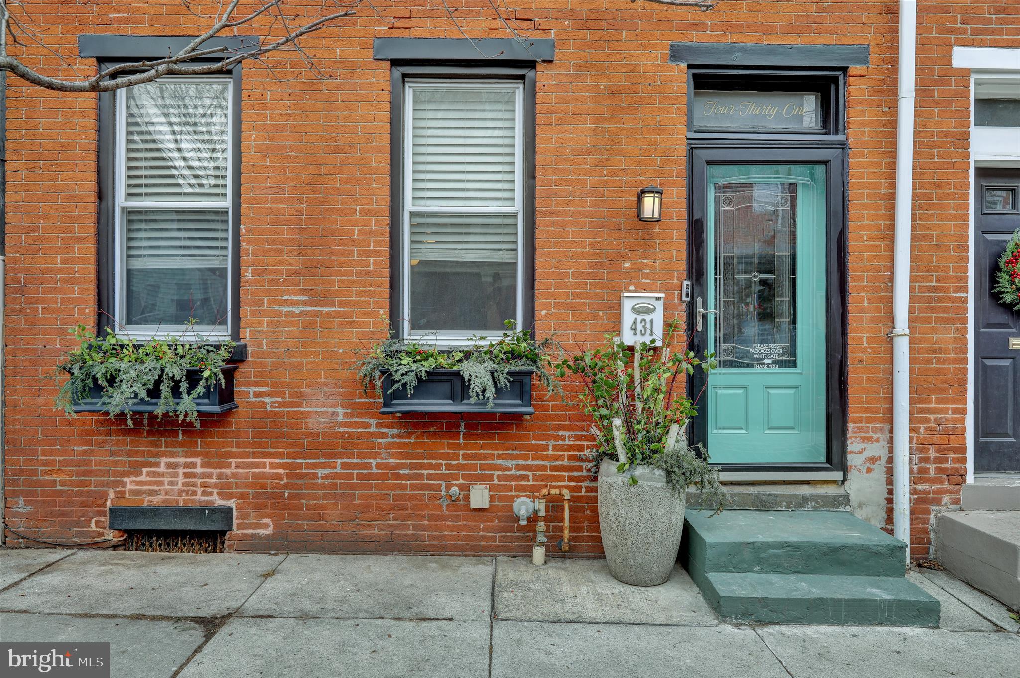 431 East Orange Street Lancaster, PA 17602 - Photo 3 of 46 a view of a brick house with potted plants