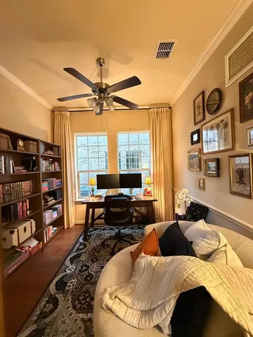 a bedroom with a bed a large window and book shelf