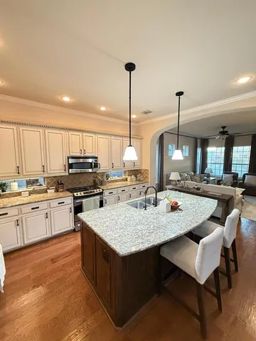 a kitchen with a stove a sink and a refrigerator
