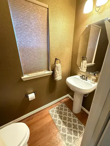 a bathroom with a sink a toilet and mirror