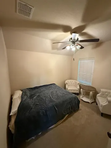 a bedroom with bed and window