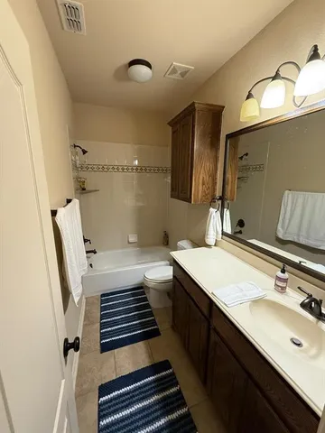 a bathroom with a sink a toilet and mirror