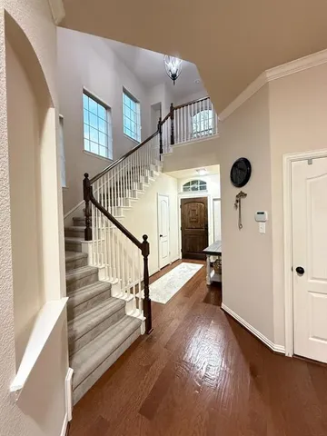 a view of entryway and hall with wooden floor