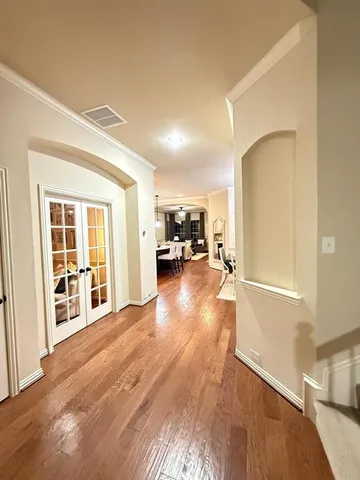 a view of a living room with furniture and wooden floor