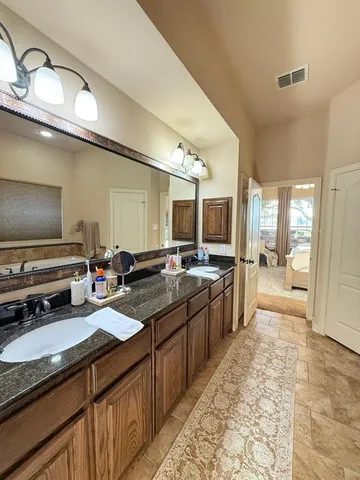 a large kitchen with a large counter top appliances and cabinets