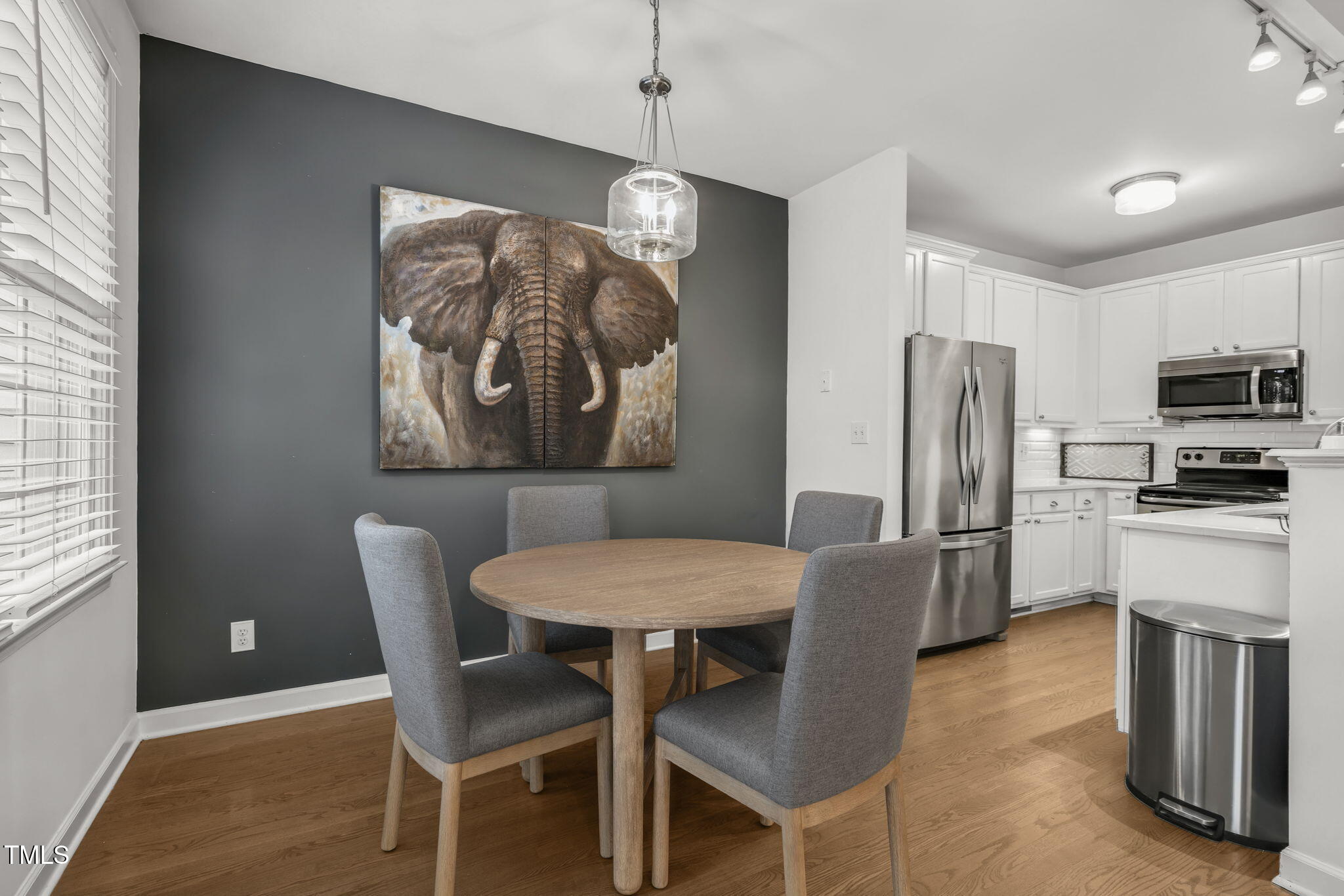4555 Treerose Way Raleigh, NC 27606 - Photo 11 of 37 a dining room with furniture a chandelier and window