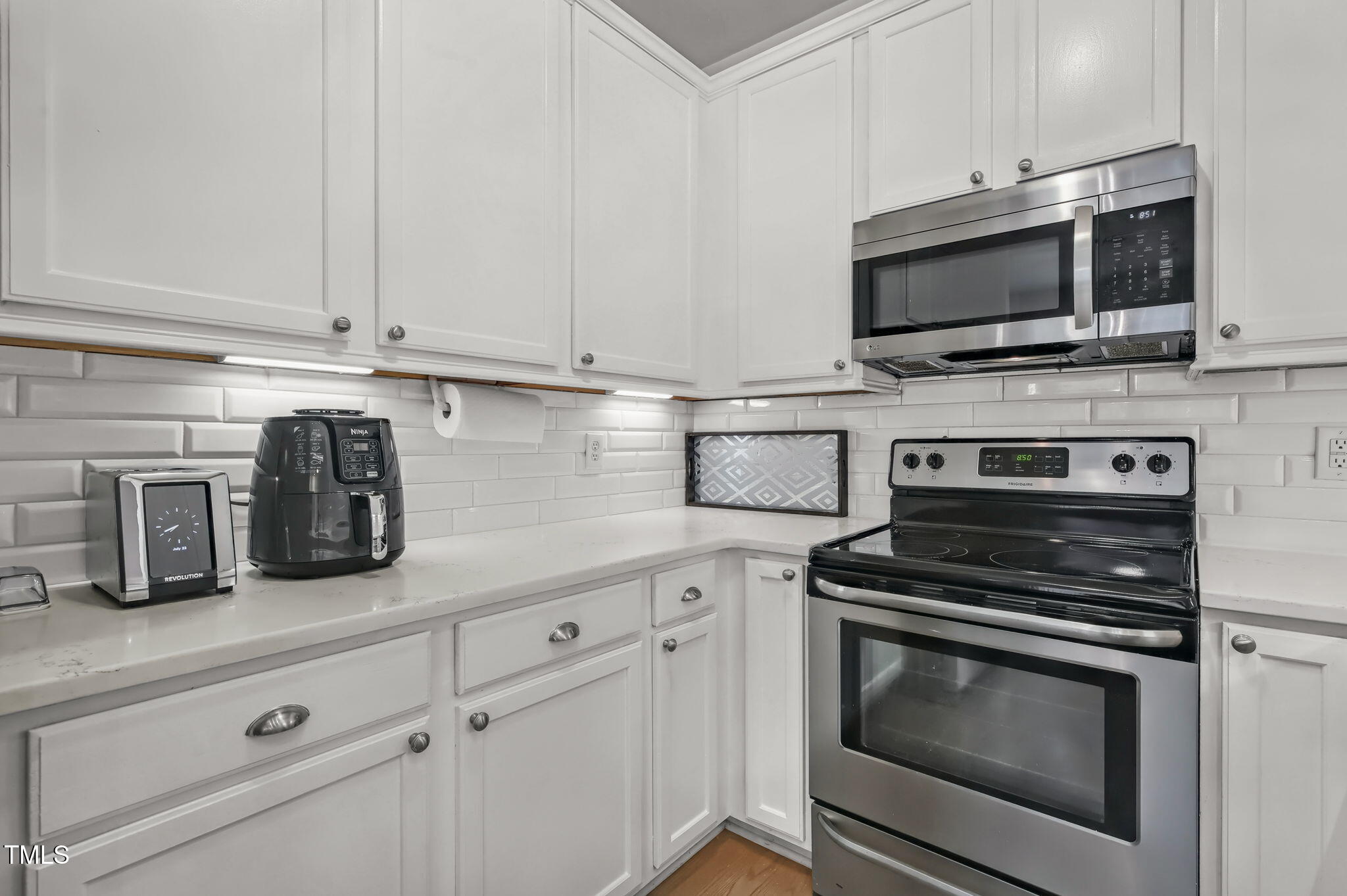 4555 Treerose Way Raleigh, NC 27606 - Photo 14 of 37 a kitchen with granite countertop a stove microwave and sink