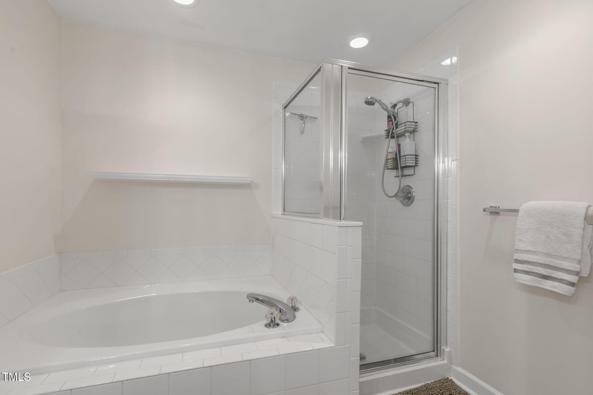 4555 Treerose Way Raleigh, NC 27606 - Photo 21 of 37 a bathroom with a bathtub and a shower