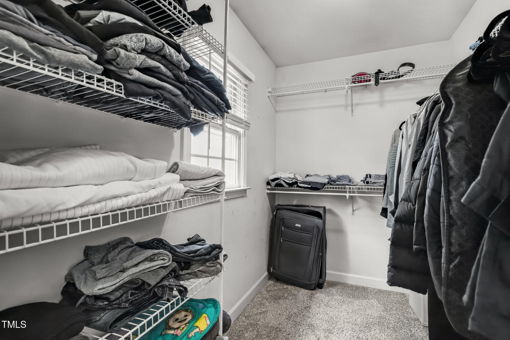 4555 Treerose Way Raleigh, NC 27606 - Photo 22 of 37 a view of walk in closet with clothes and shoes