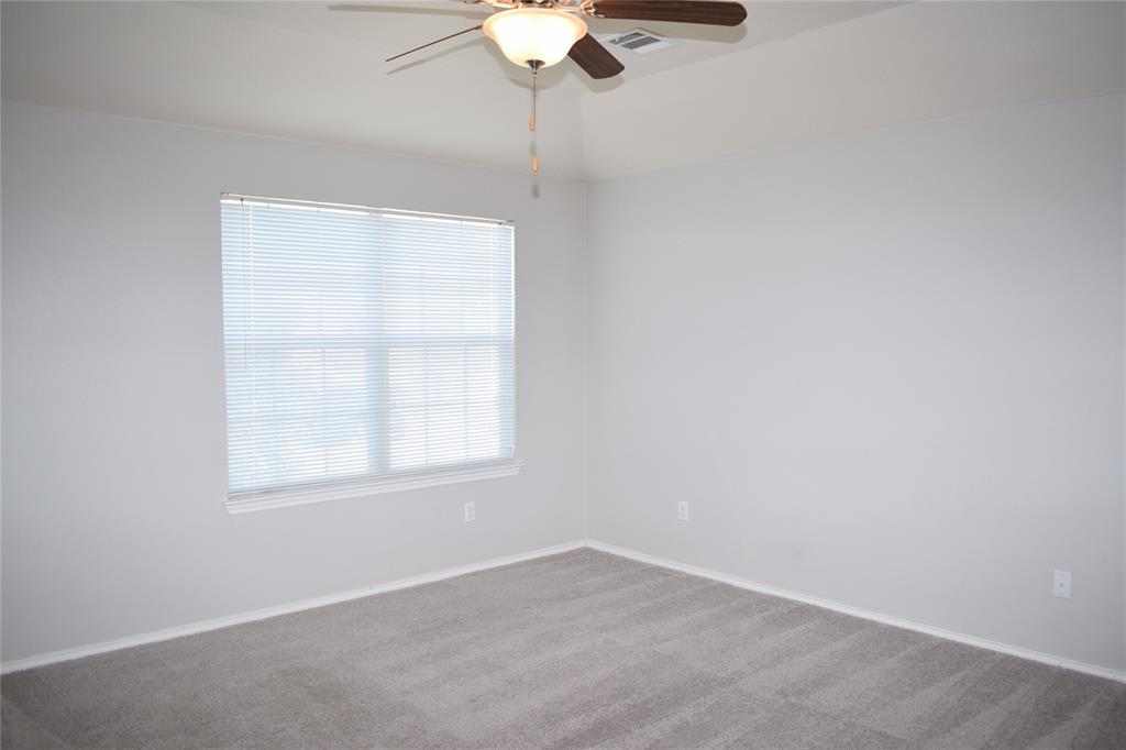 375 Housefinch Loop Leander, TX 78641 - Photo 11 of 28 Plush carpeting anchors this versatile room boasting high ceilings and a wide window.