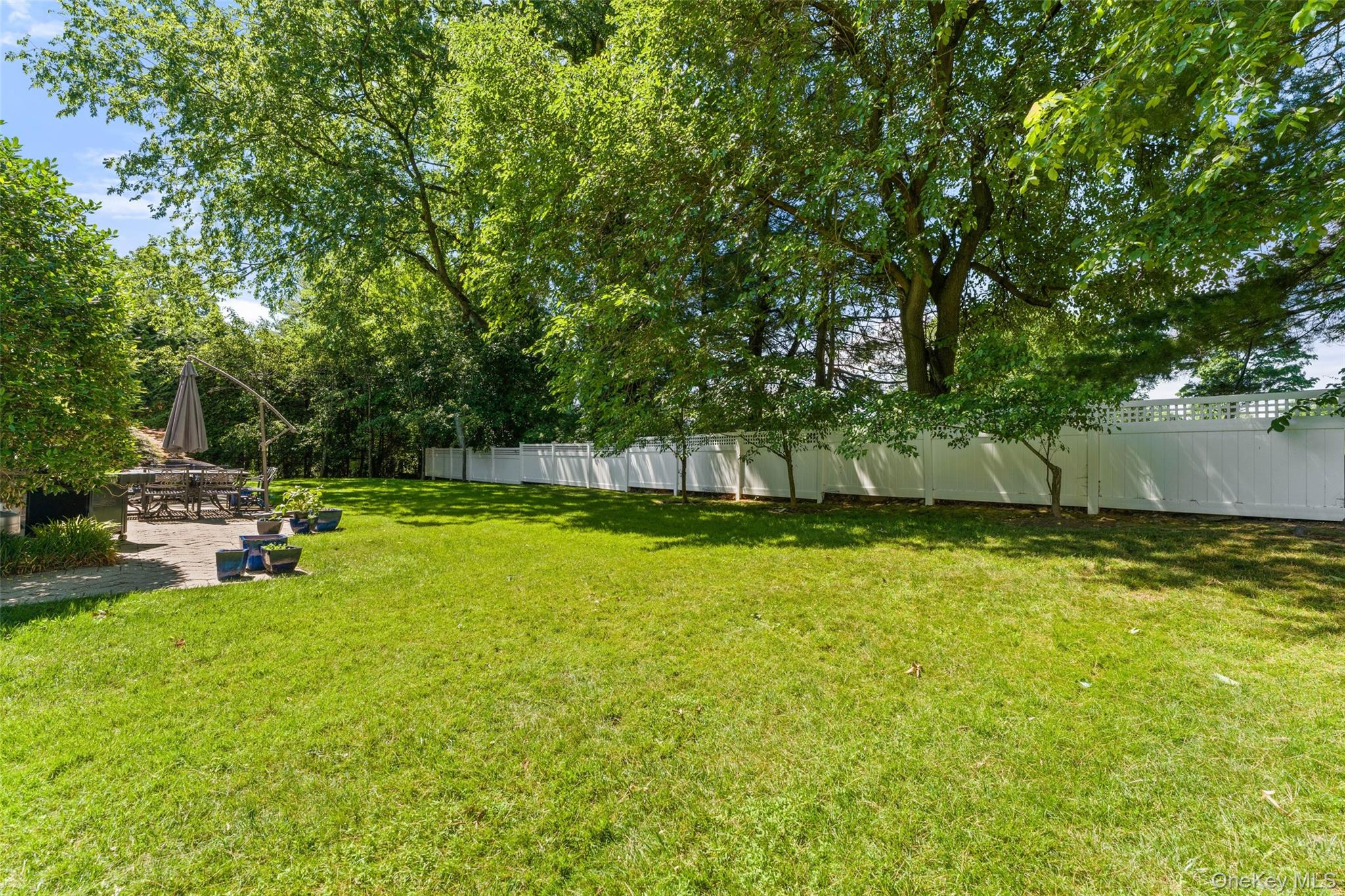 6 Magnetti Circle Mamaroneck, NY 10543 - Photo 21 of 24 a view of a swimming pool with a bench and trees around