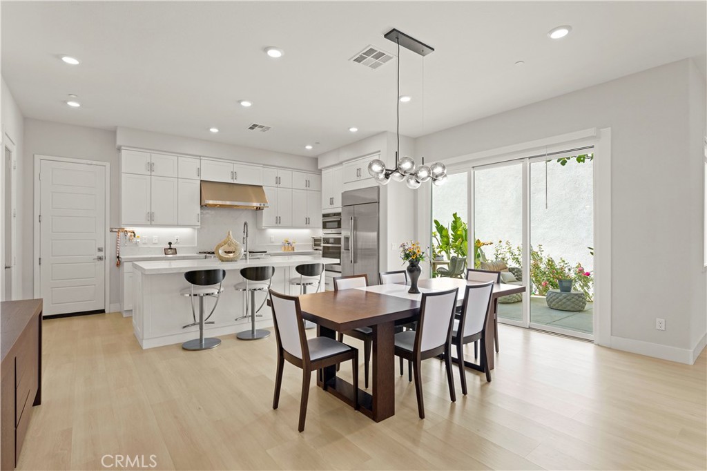 259 Chorus Irvine, CA 92618 - Photo 12 of 56 a view of a dining room and livingroom with furniture wooden floor a chandelier