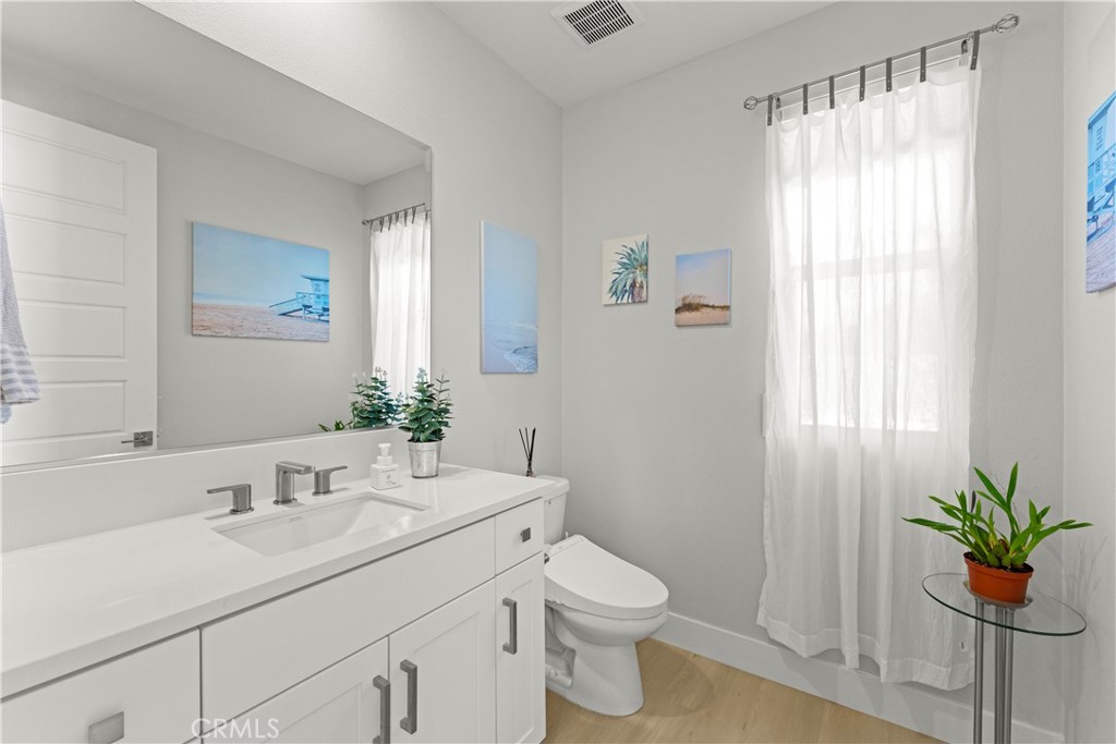 259 Chorus Irvine, CA 92618 - Photo 27 of 56 a bathroom with a sink a toilet and a large mirror