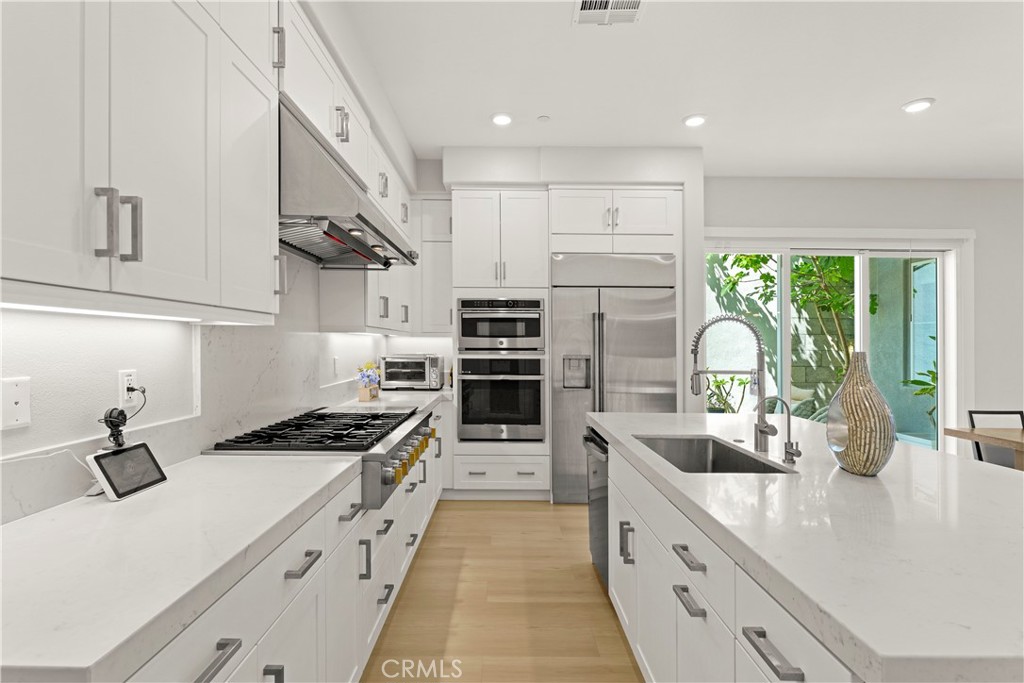 259 Chorus Irvine, CA 92618 - Photo 31 of 56 a kitchen with stainless steel appliances a sink stove and cabinets