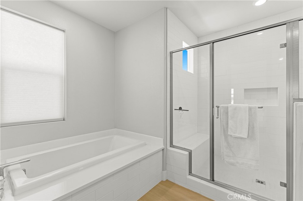 259 Chorus Irvine, CA 92618 - Photo 33 of 56 a bathroom with a bathtub and a shower