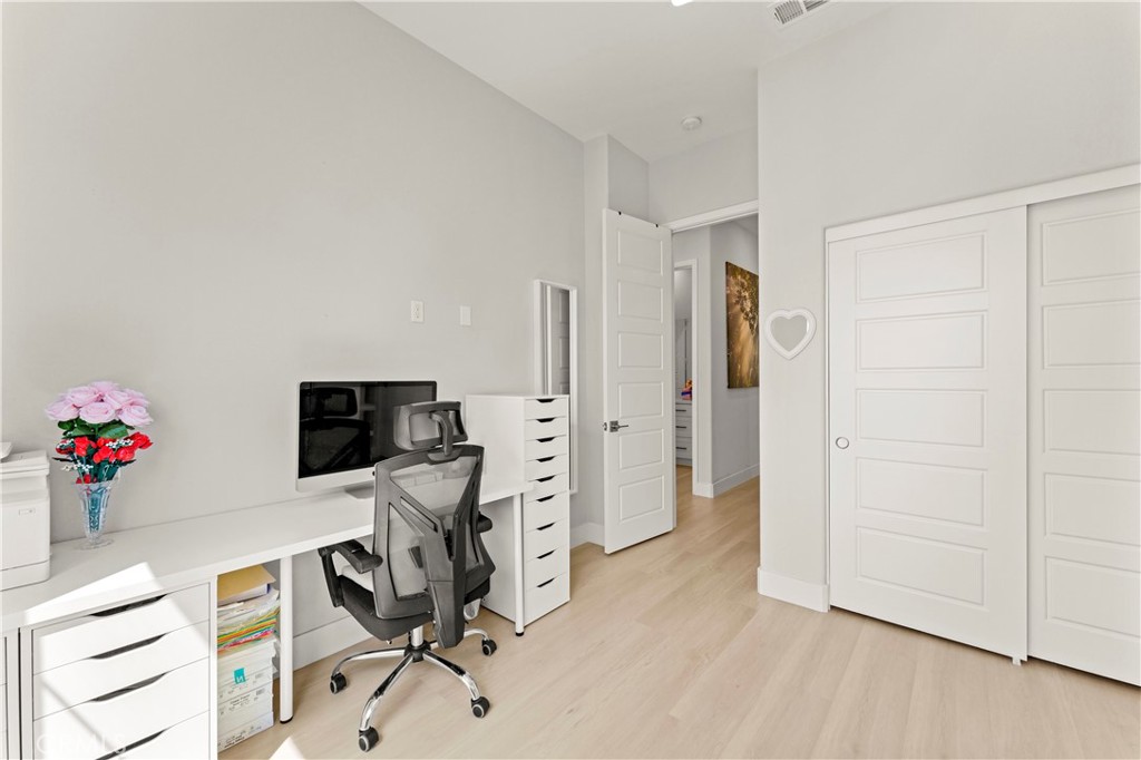 259 Chorus Irvine, CA 92618 - Photo 37 of 56 a view of a workspace with furniture and wooden floor
