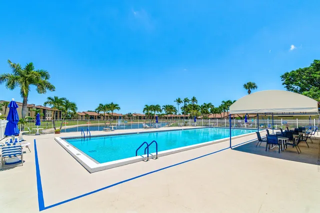 a view of a house with backyard and porch
