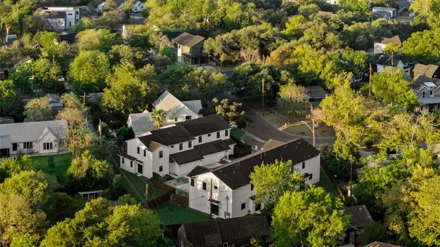 an aerial view of a house with a yard